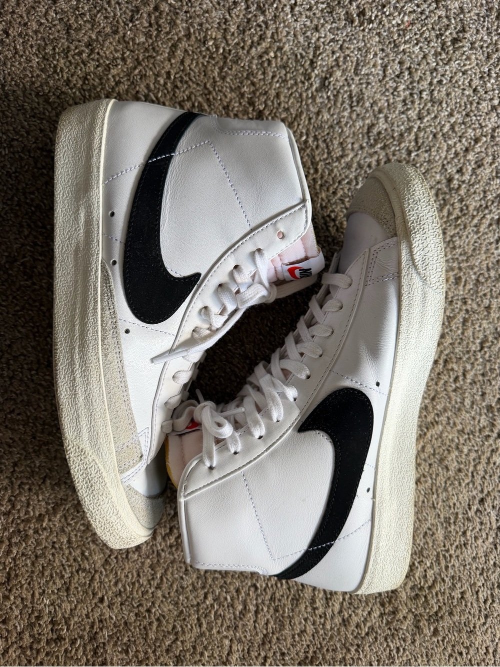 Nike White High-Top Sneakers with Black Swoosh